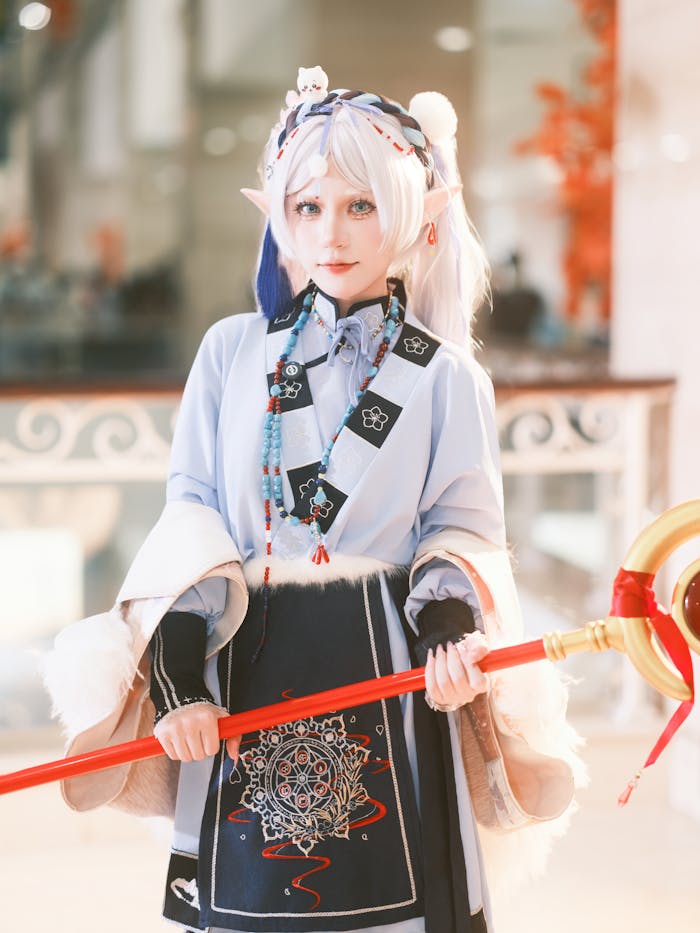 services-01 Portrait of a person in elaborate fantasy cosplay costume holding a magical staff.